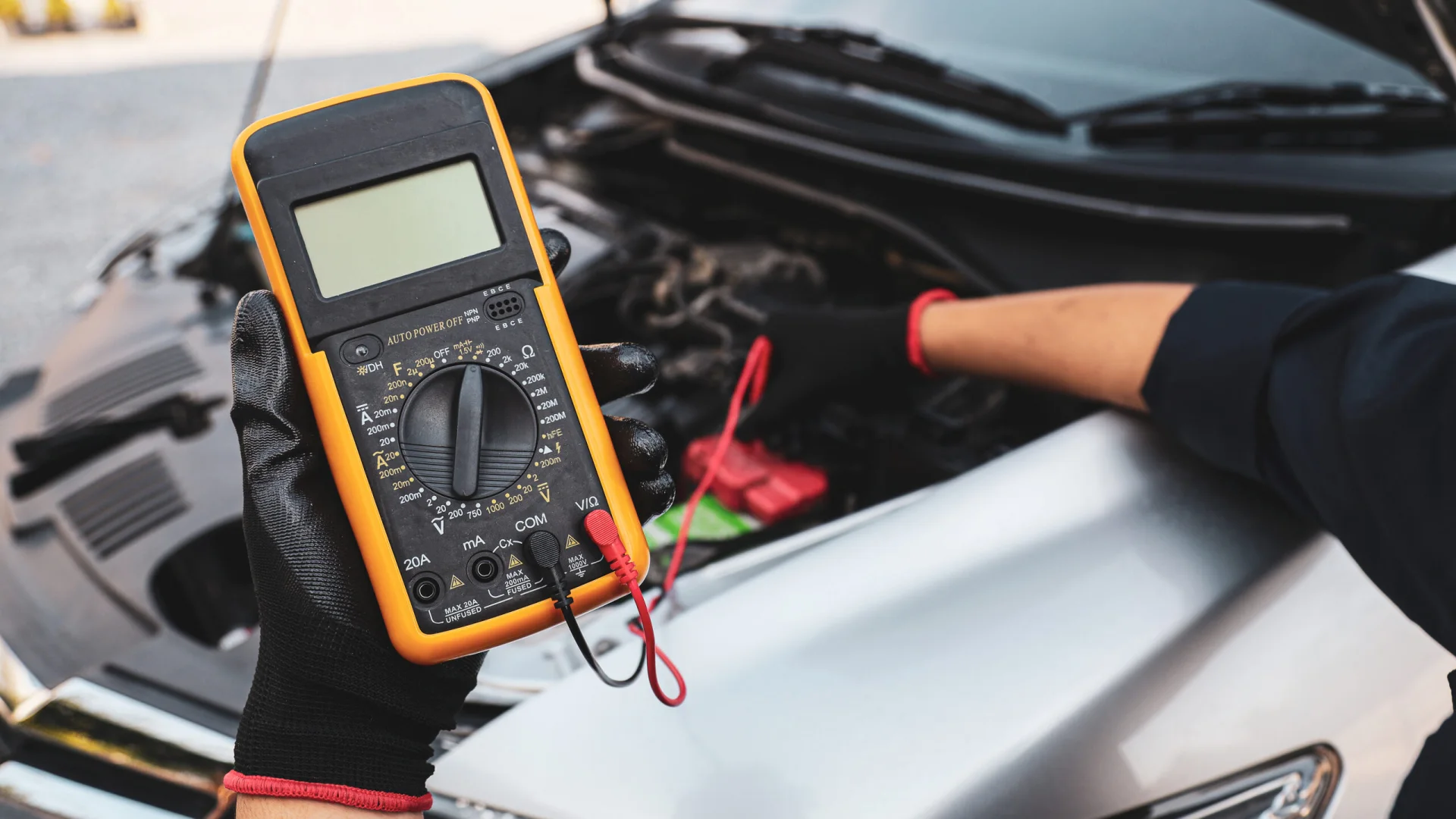 Technician testing a car battery during mobile service
