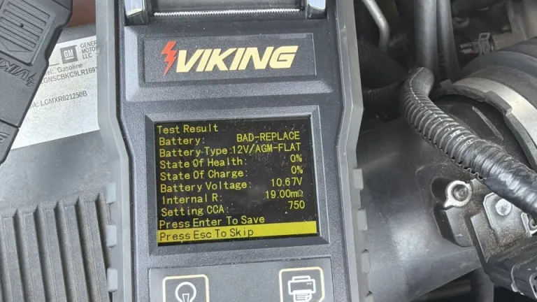 Technician testing a car battery during roadside service