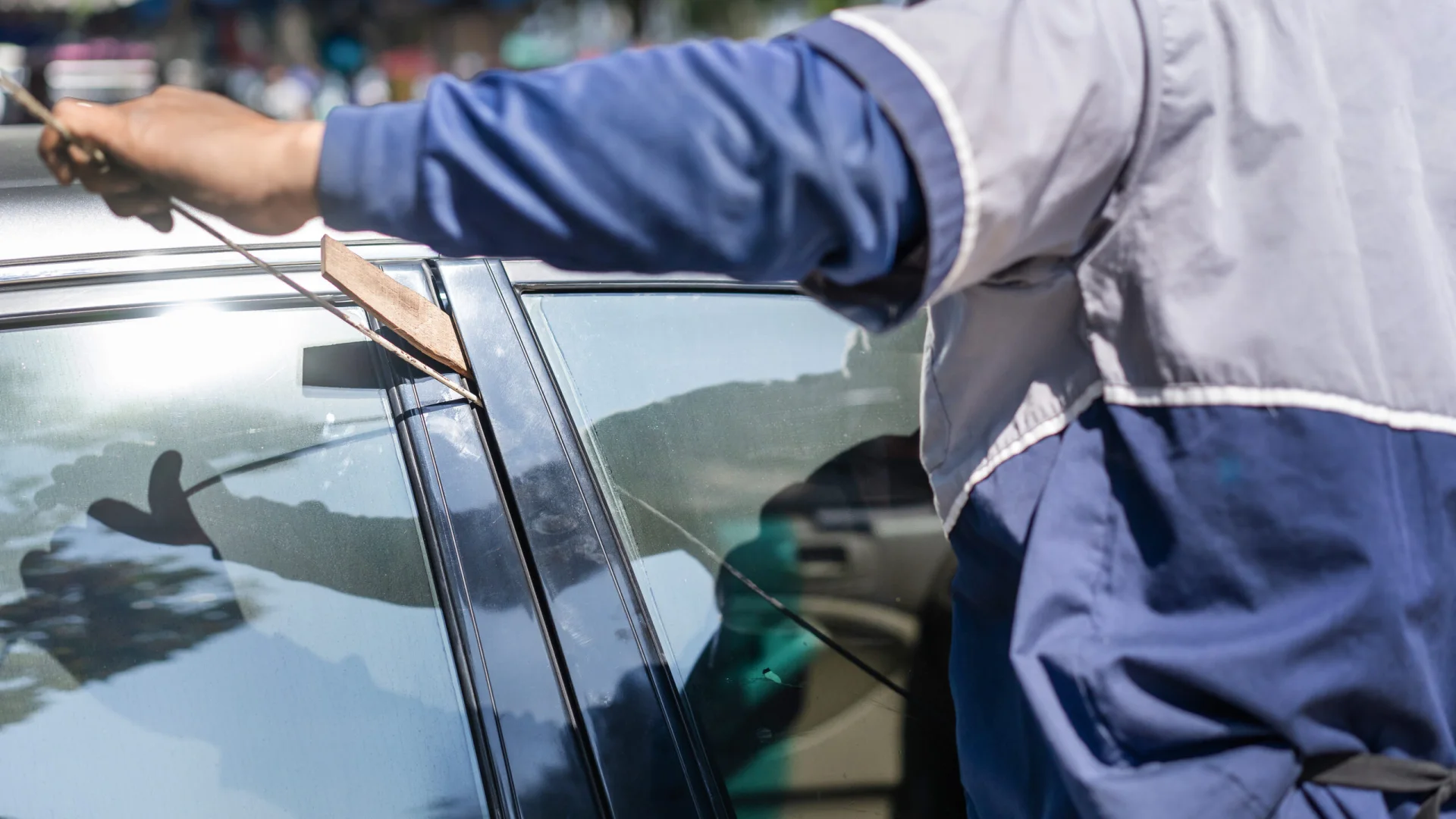 Technician unlocking a vehicle during roadside lockout assistance