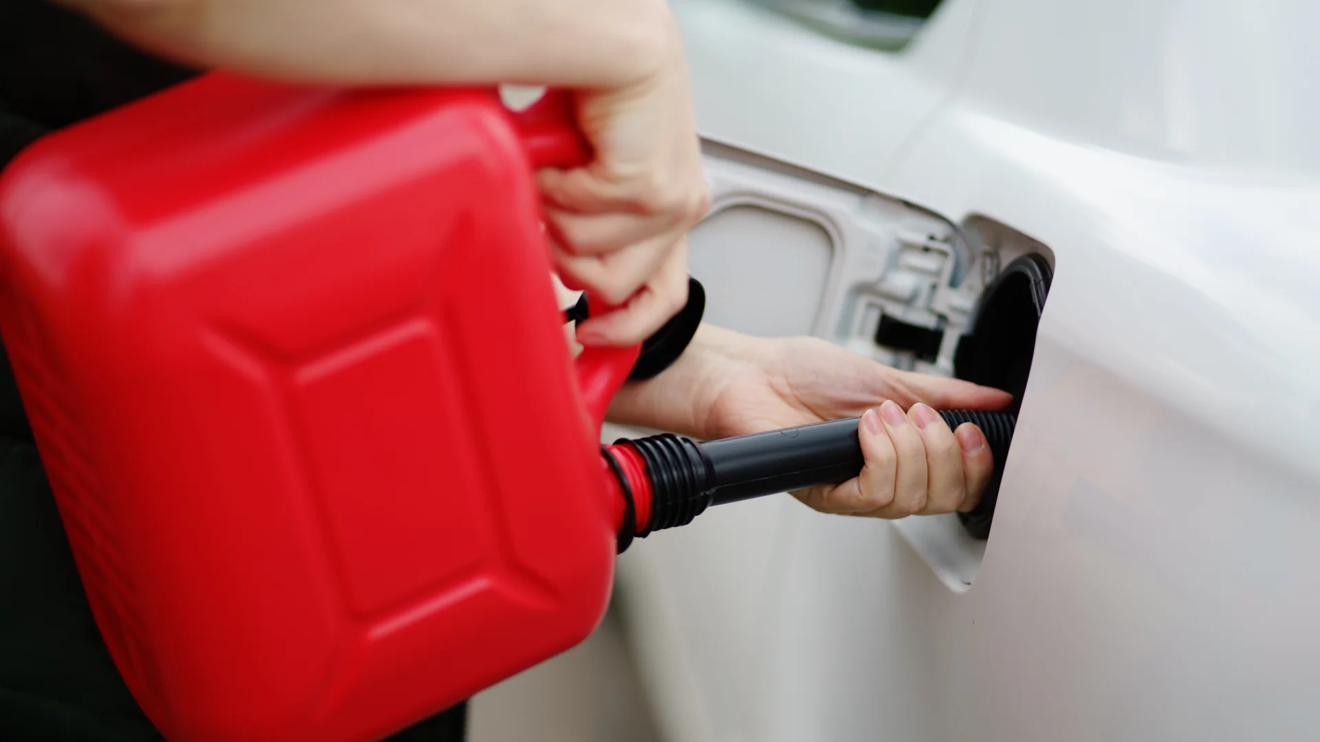 Fuel being poured into a vehicle during roadside assistance