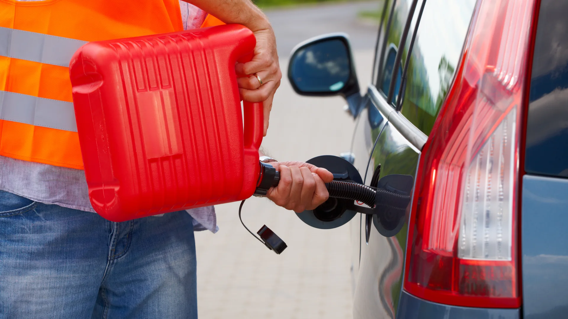 Service technician adding emergency fuel to a vehicle